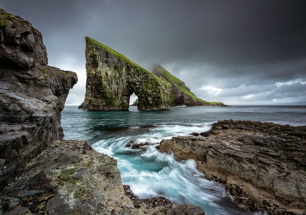rock formation on body of water Faroe Islands Unveiling Earth's Treasures