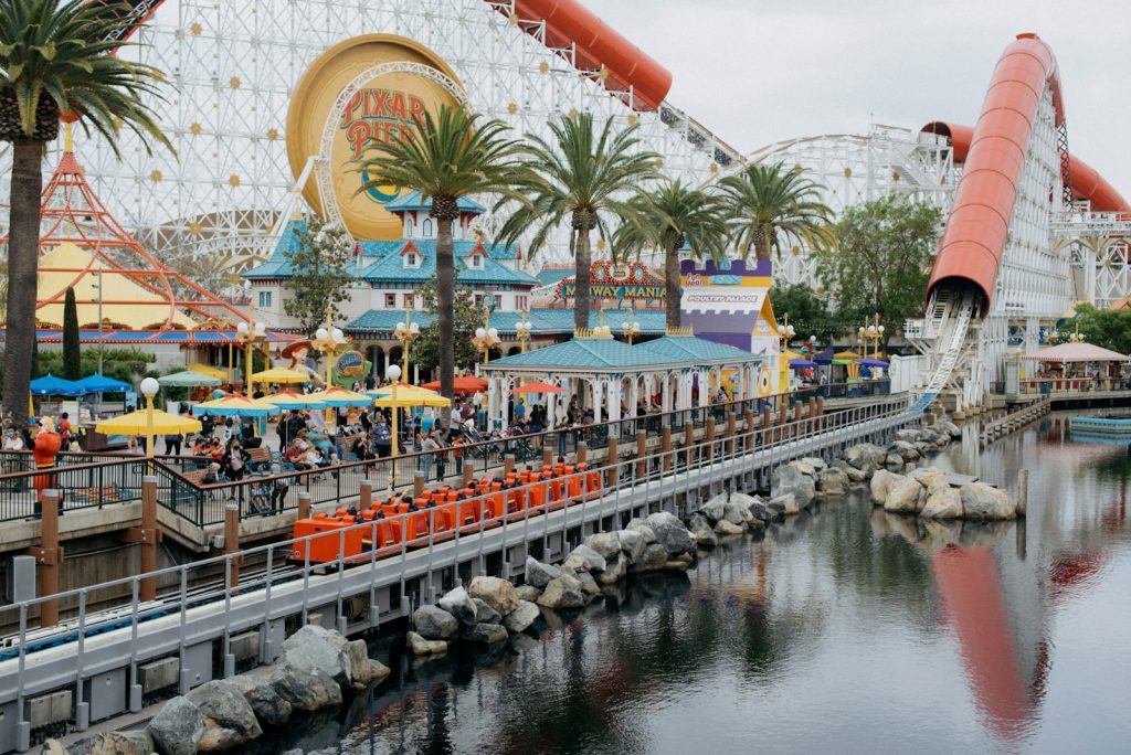 a roller coaster ride next to a body of water Theme Park Thrills Exploring Family-Friendly Resorts
