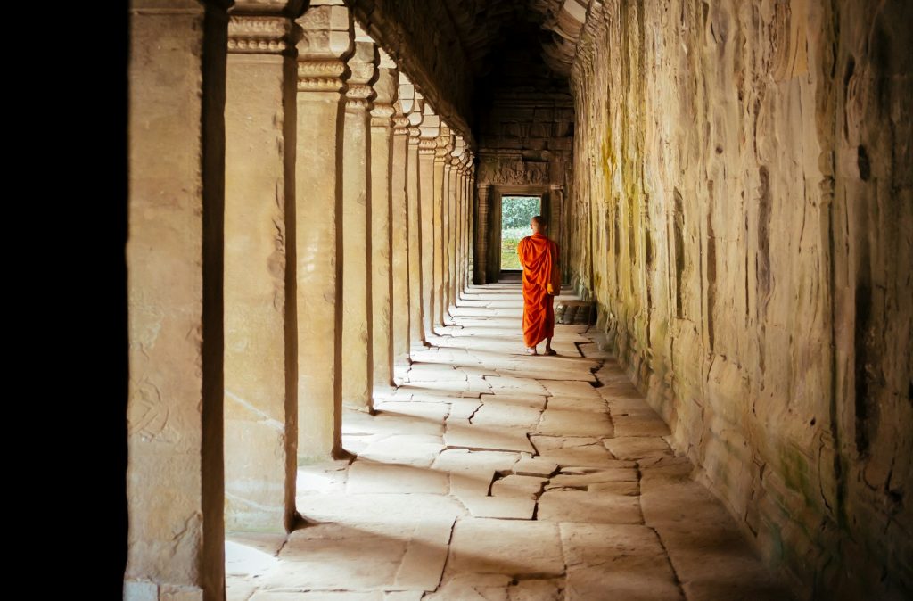 selective focus photography of monk at corridor Cultural Sensitivity Enriching Journeys