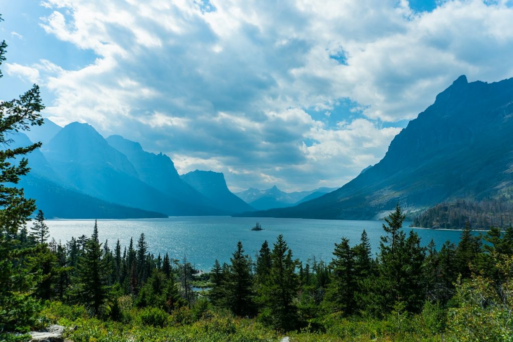a scenic view of a lake surrounded by mountains Glacier National Park  Into the Wild