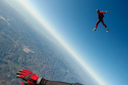 man in red and black outfit air diving