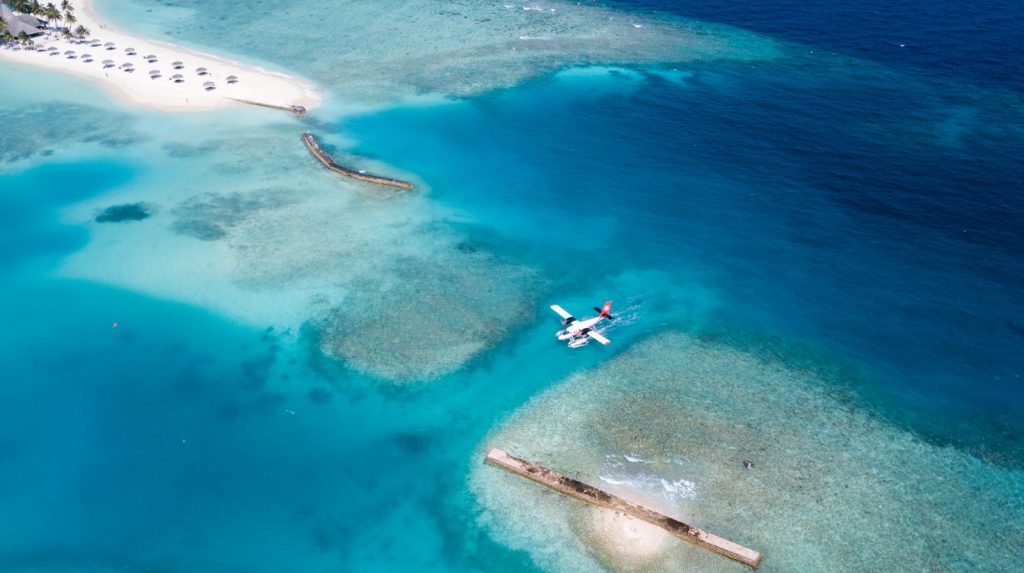 top view of white plane on body of water Beach Resorts Exploring Family-Friendly Resorts