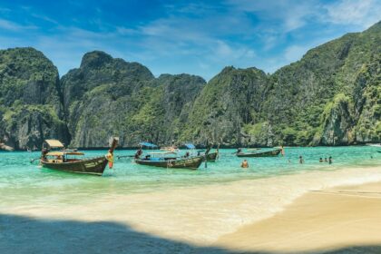 people riding on boat on beach during daytime