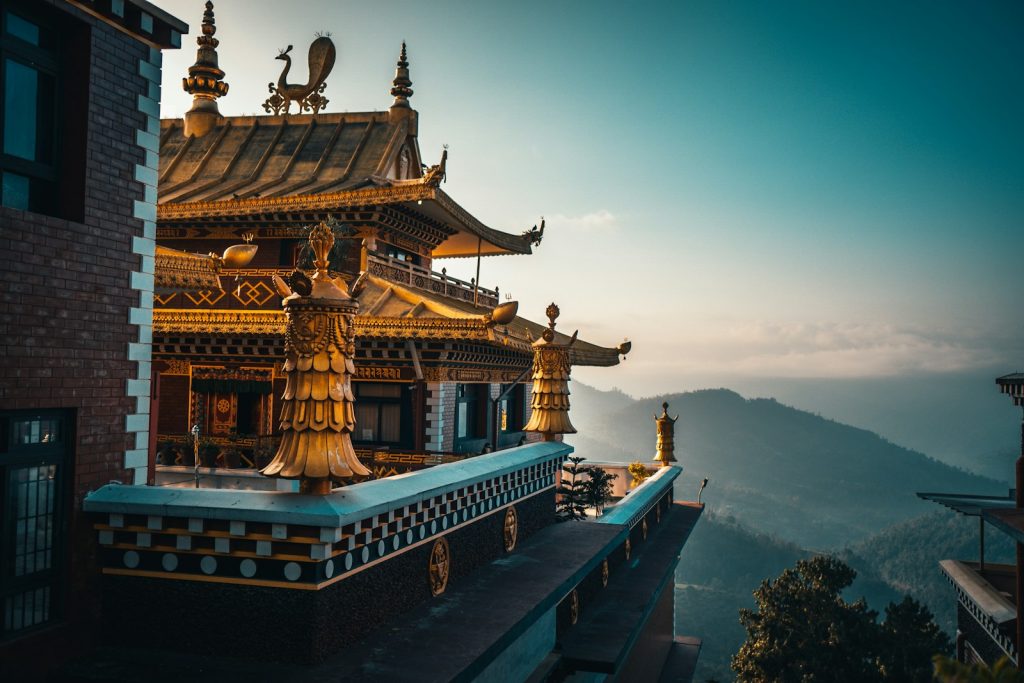 brown and green temple on top of mountain during daytime Preserving Natural and Cultural Heritage Embracing the Unseen