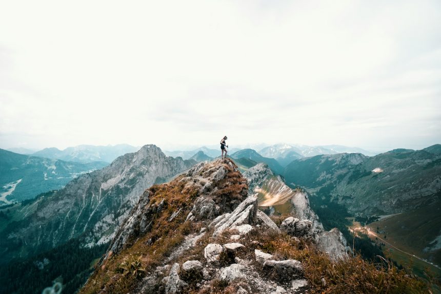 person standing on mountain during daytime