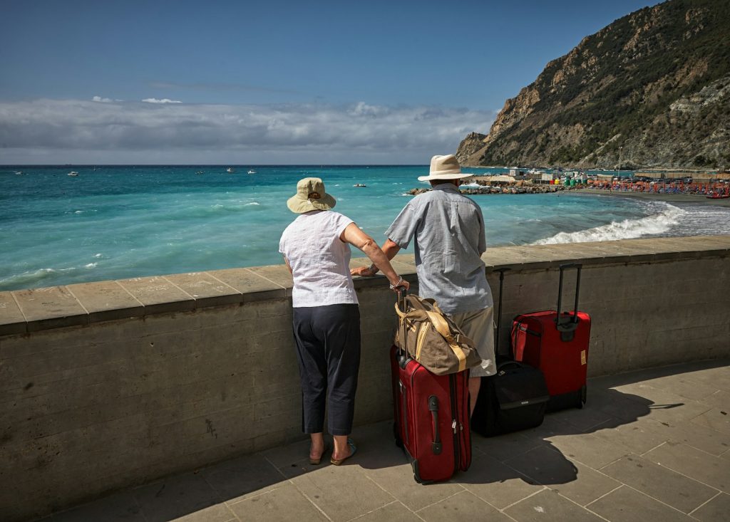 man and woman standing beside concrete seawall looking at beach Connecting with Fellow Travelers The Heart of Europe