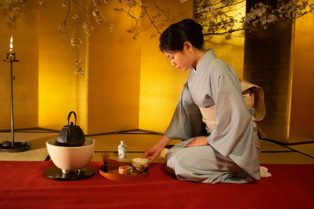 woman siting inside room art of tea ceremony in Kyoto