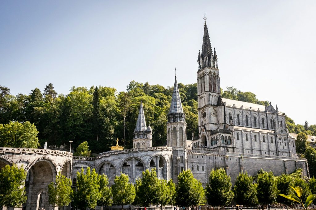 a large building with a steeple on top of it Lourdes Journeys of the Soul