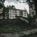 gray concrete building near green trees during daytime