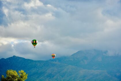 two hot air balloons near mountain