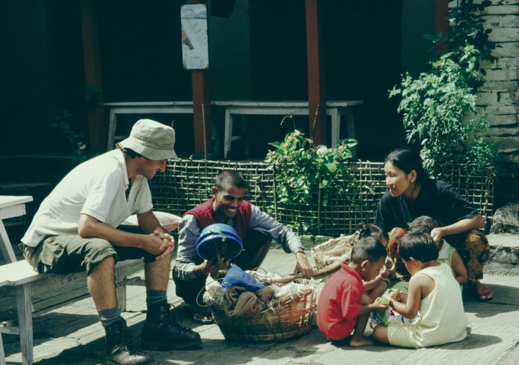 a group of people sitting on a porch next to each other Cultural Immersion The Modern Wanderer