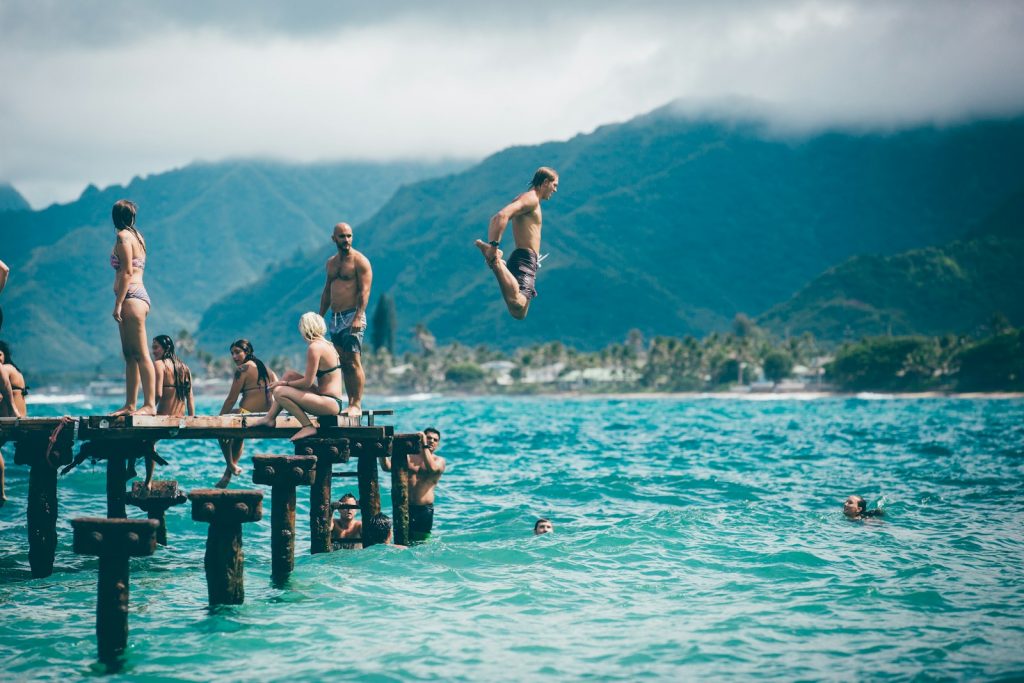 man diving from dock with people Gestures and Body Language  Embracing Diversity
