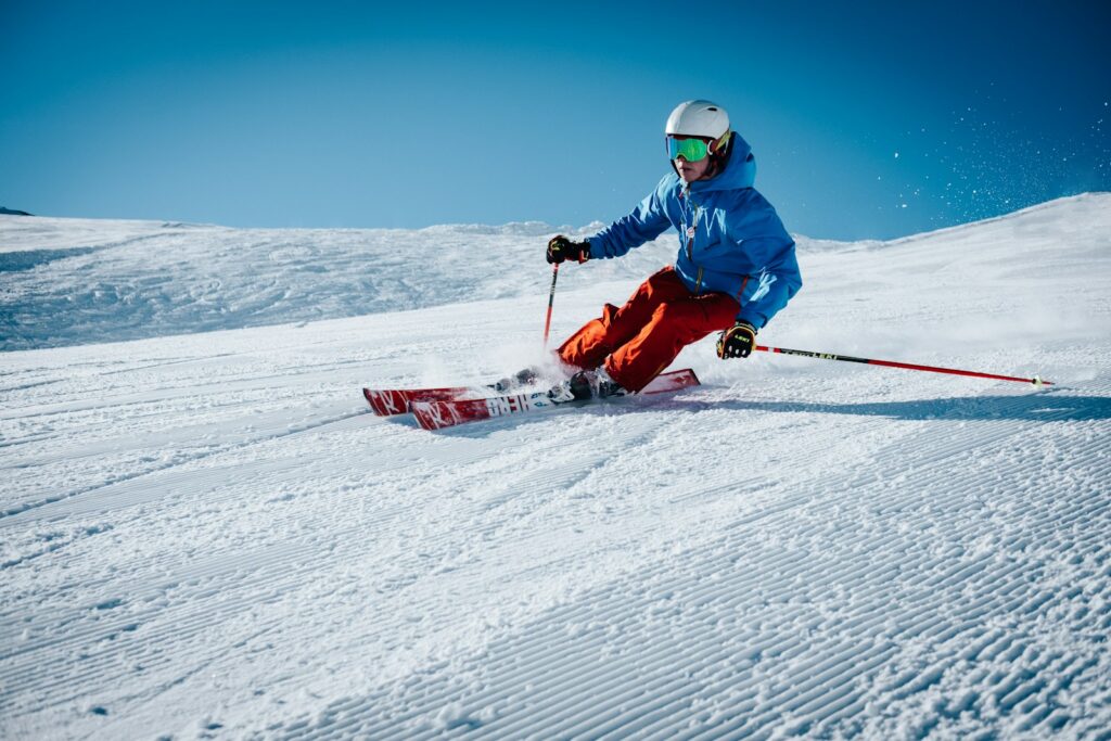 man ice skiing on hill Global Skiing Hotspots Alpine Adventure