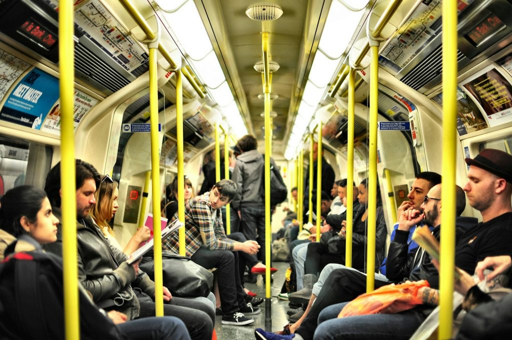 photo of group on people sitting inside train Use public transportation Unlocking the World on a Budget