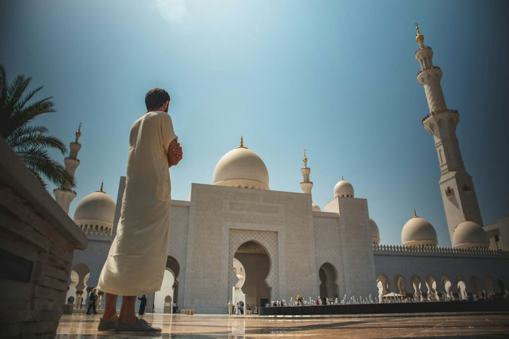 man standing near white mosque Exploring architectural wonders