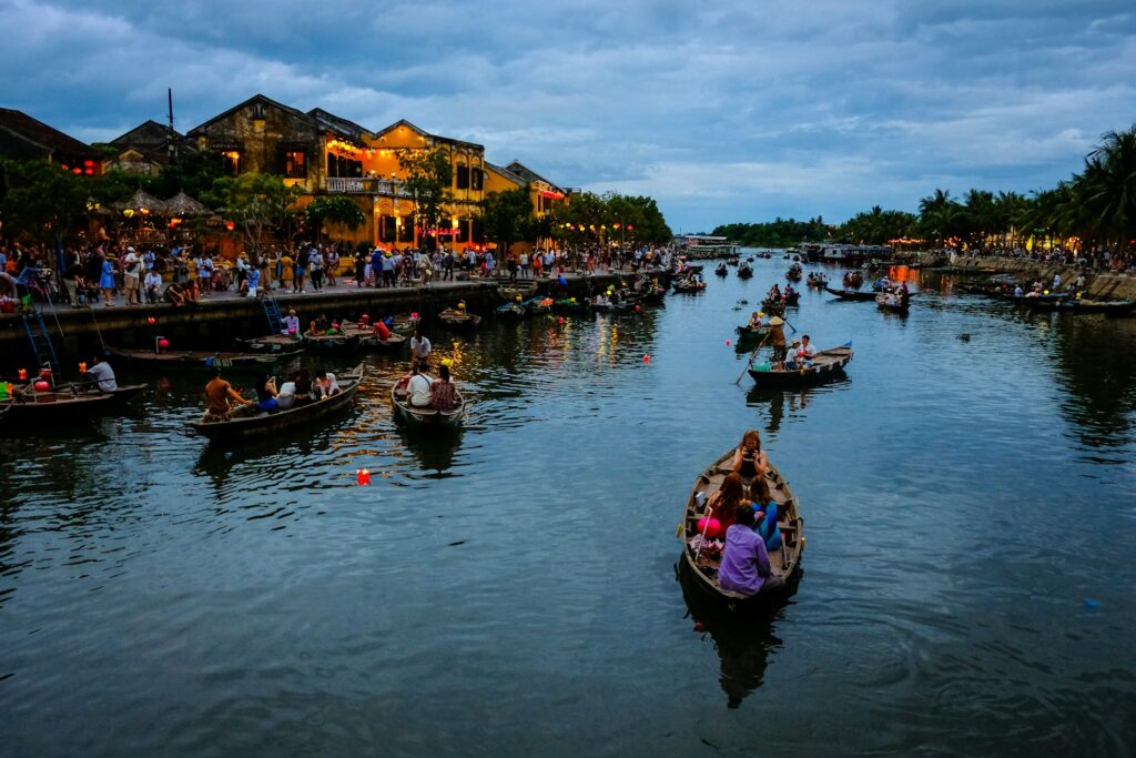 people riding on boat on river during daytime Unveiling 7 Facts about Da Nang: Discovering its Intriguing Charms