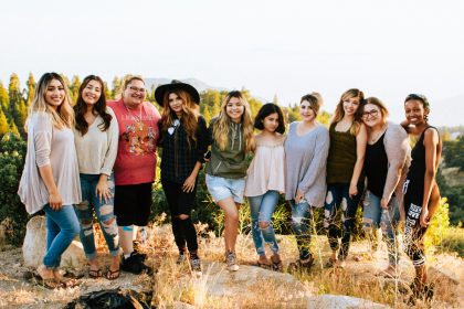 group of women standing on rock fragment