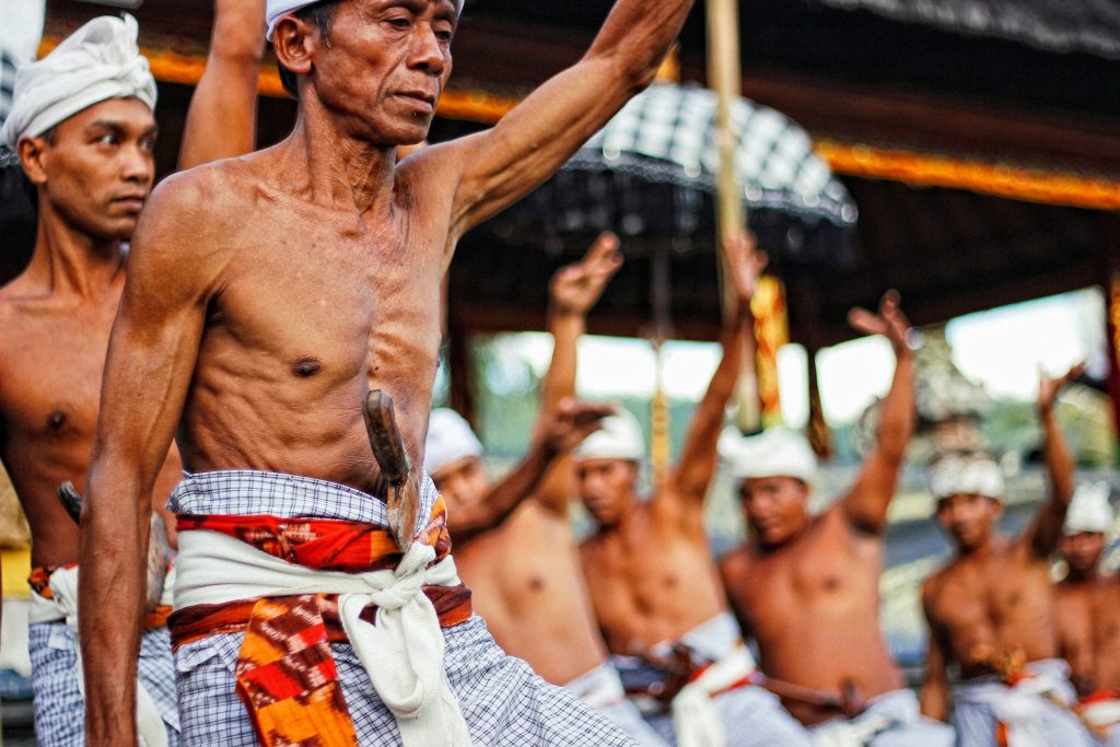 man with knife on stomach raising hands Tips for Experiencing Local Festivals Embracing Culture