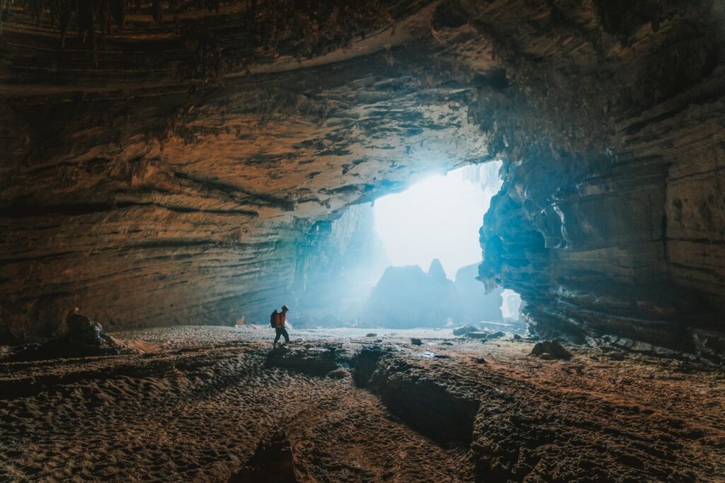 person walking towards cave Hang Sơn Đoòng World's Largest Caves