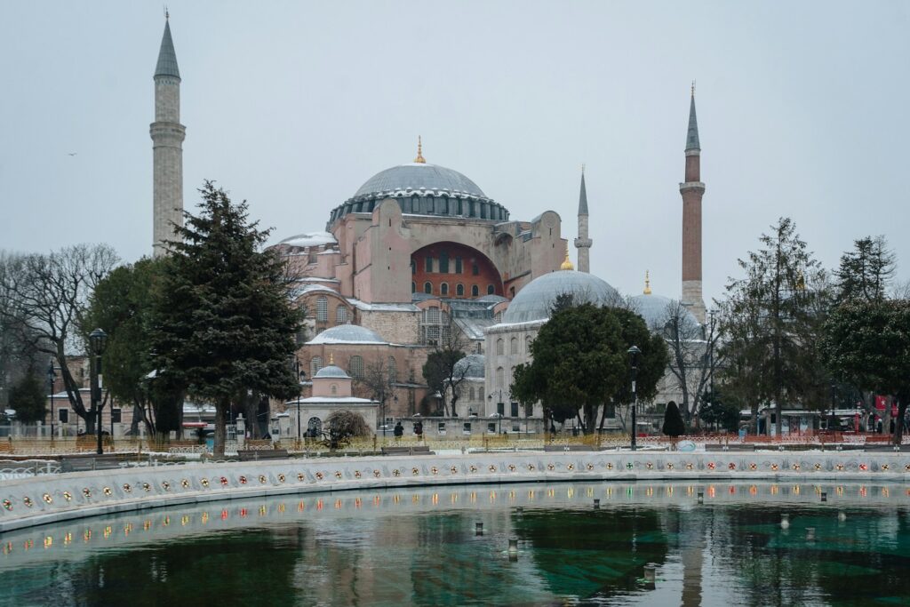 a large building with towers and domes with Hagia Sophia in the background Rich Tapestry of Turkey