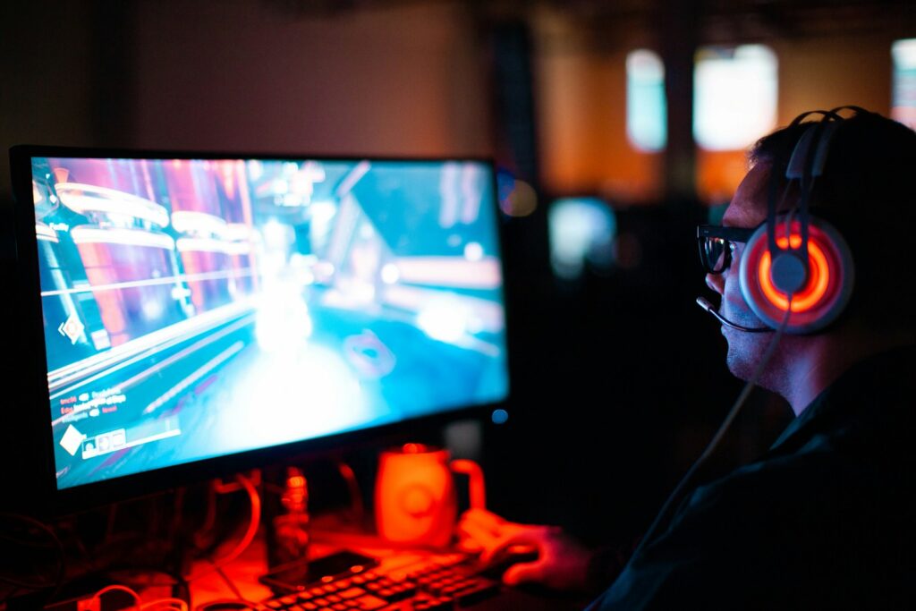 person using computer playing FPS game game purchases Plarium Play Universe