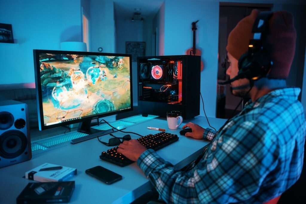a person wearing headphones and using a computer Benefits of Prime Gaming 
