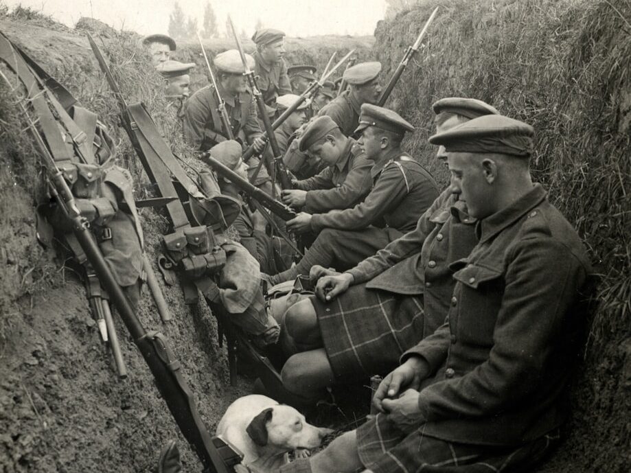 a group of men sitting next to each other in a trench The Mergest Kingdom