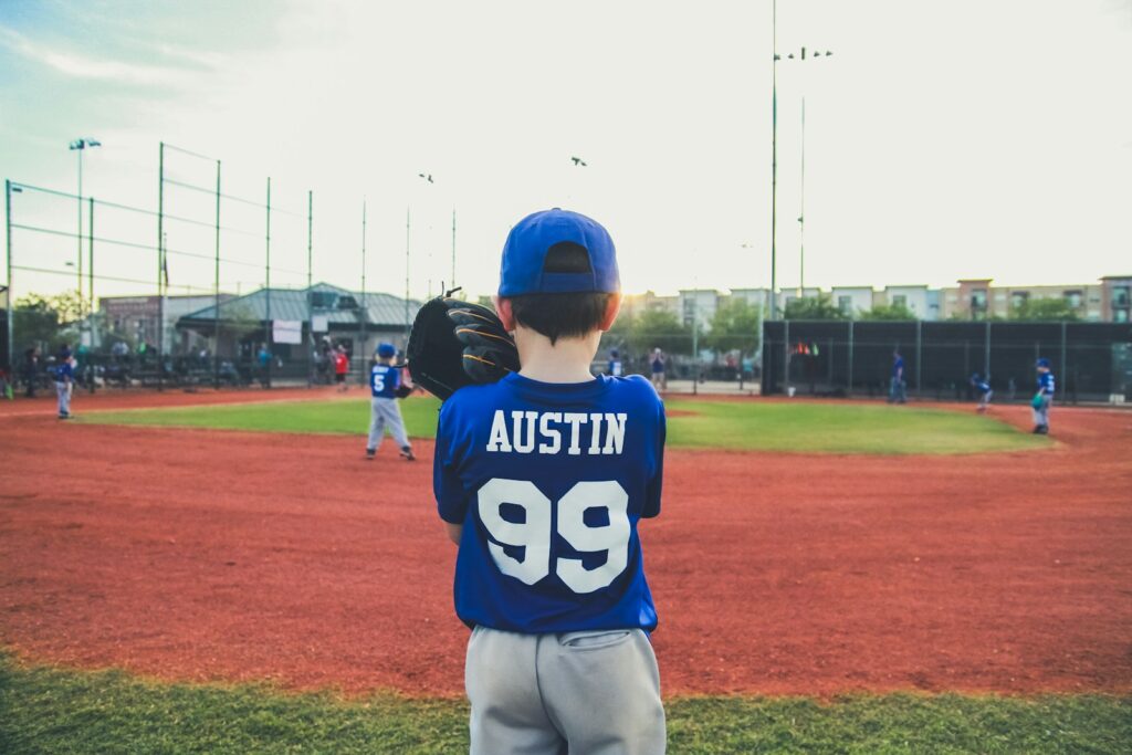 boy in blue and white shirt standing on green grass Games for All Ages Unleashed for Kids and Adults