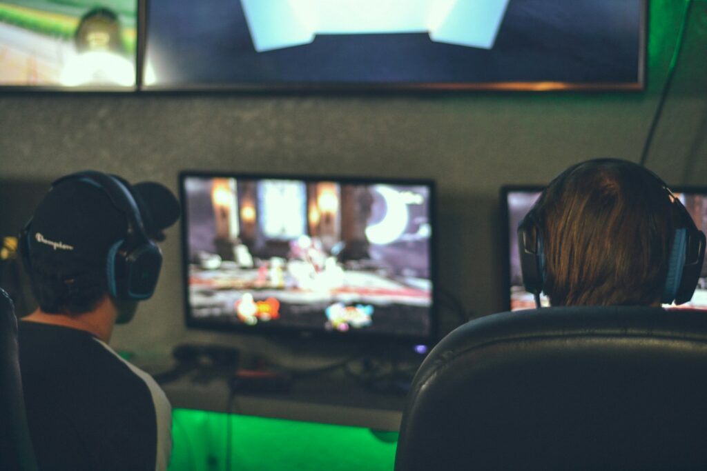 selective focus photography of two persons playing game in front of monitors video games World of Web Games