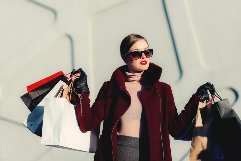 photo of woman holding white and black paper bags Fashion Boutique Manager Egirlgames