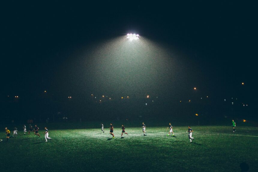 group of people playing soccer on soccer field