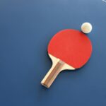 red and brown wooden table tennis racket