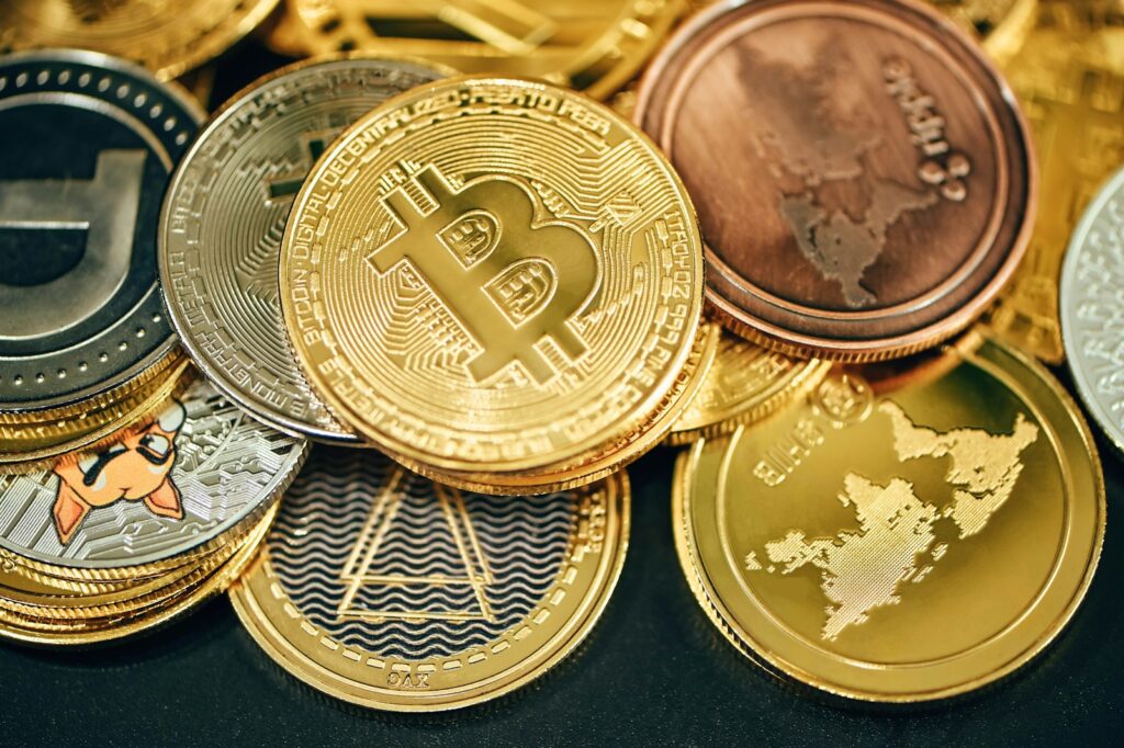 a pile of gold and silver bitcoins Efficient Money Management Earn to Die