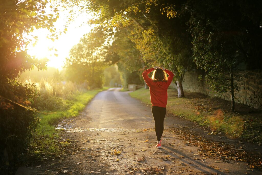 woman walking on pathway during daytime Mental Health Benefits Ping Pong Online