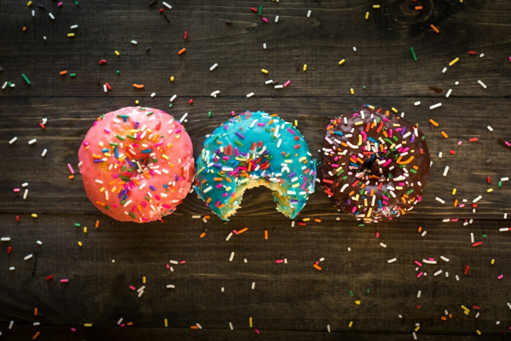 pink, blue, and chocolate with sprinkles doughnuts on table Decorations Papa's Bakeria