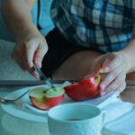 a person cutting a fruit