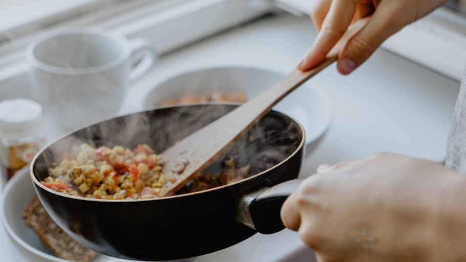 person holding black frying pan. 7 Worst Cooking Mistakes You’re Probably Making