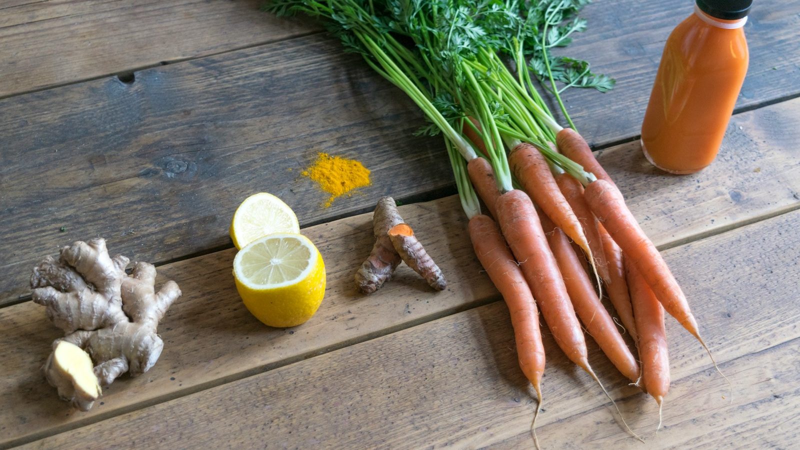 carrot and green vegetable on brown wooden table. 7 Life-Changing Healthy Smoothie Recipes