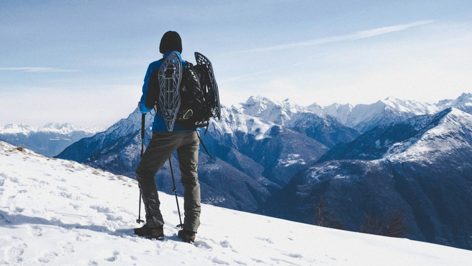 man walking on snow mountain