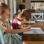 boy in gray crew neck t-shirt reading book