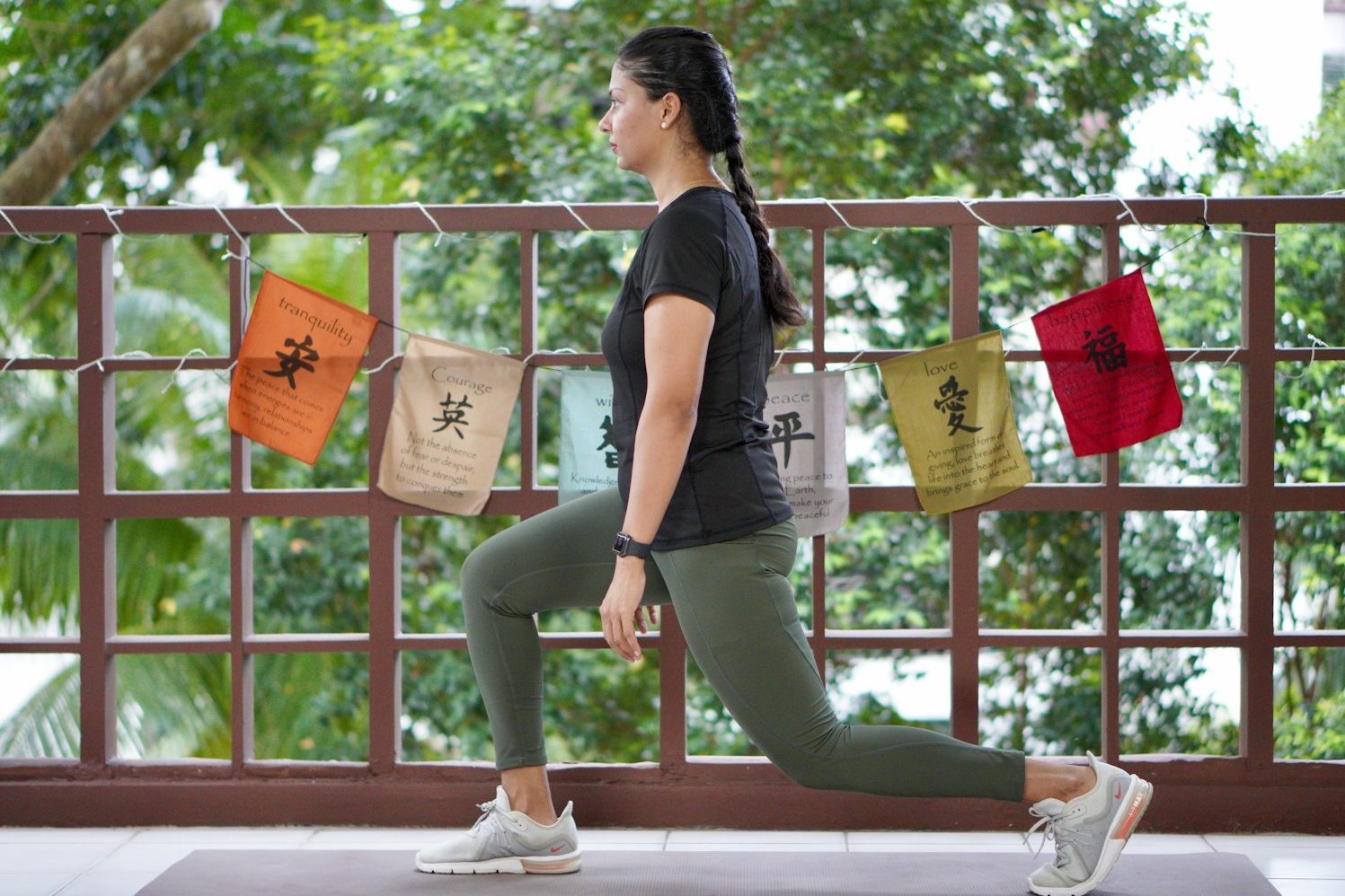 a woman in a black shirt is doing yoga