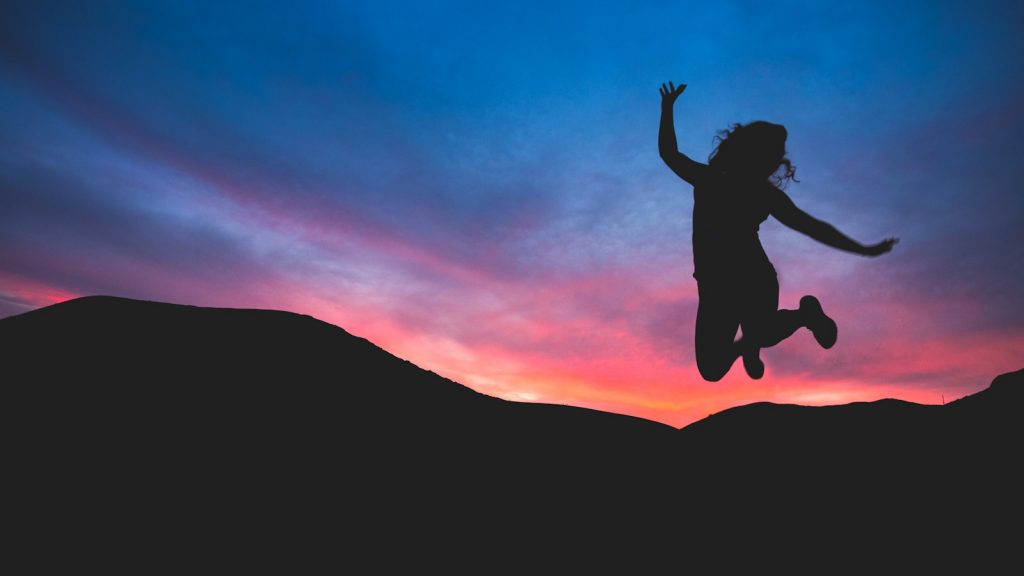 silhouette of person jumping during dawn. 7 Unstoppable Ways to Boost Your Self-Esteem