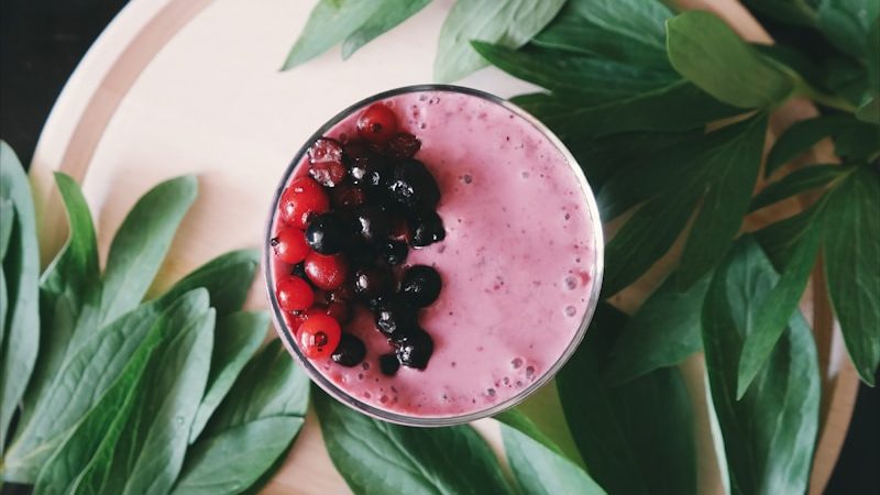 clear drinking glass with juice on white plate. 7 Life-Changing Healthy Smoothie Recipes