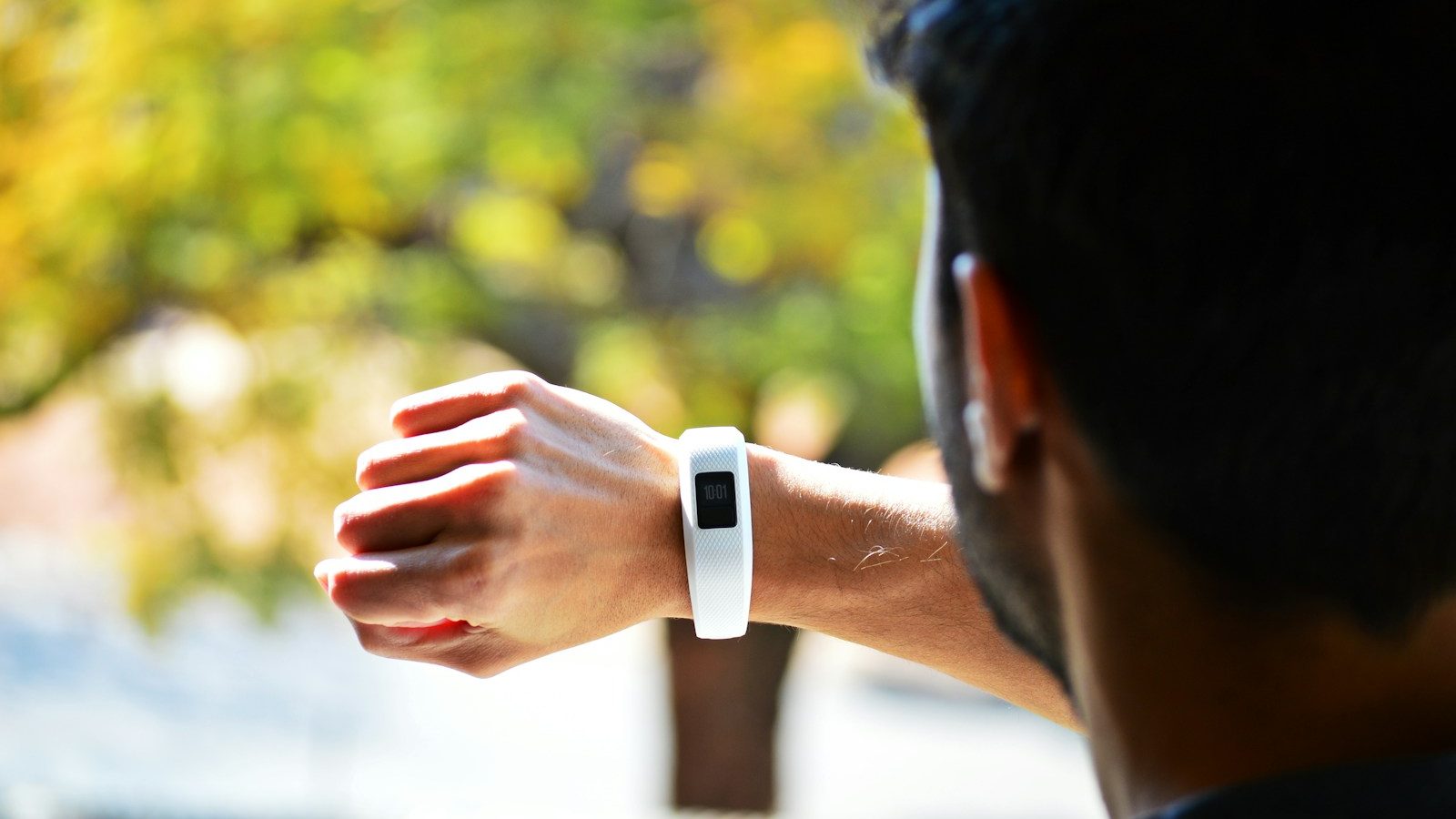 man looking at activity tracker