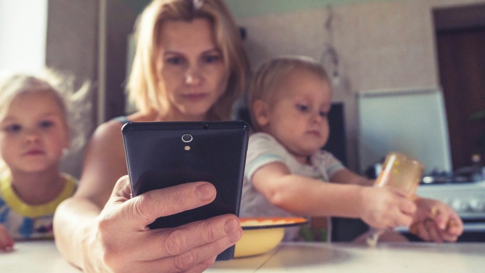 woman in white shirt holding black ipad. 6 Worst Mistakes Parents Make When Disciplining Children