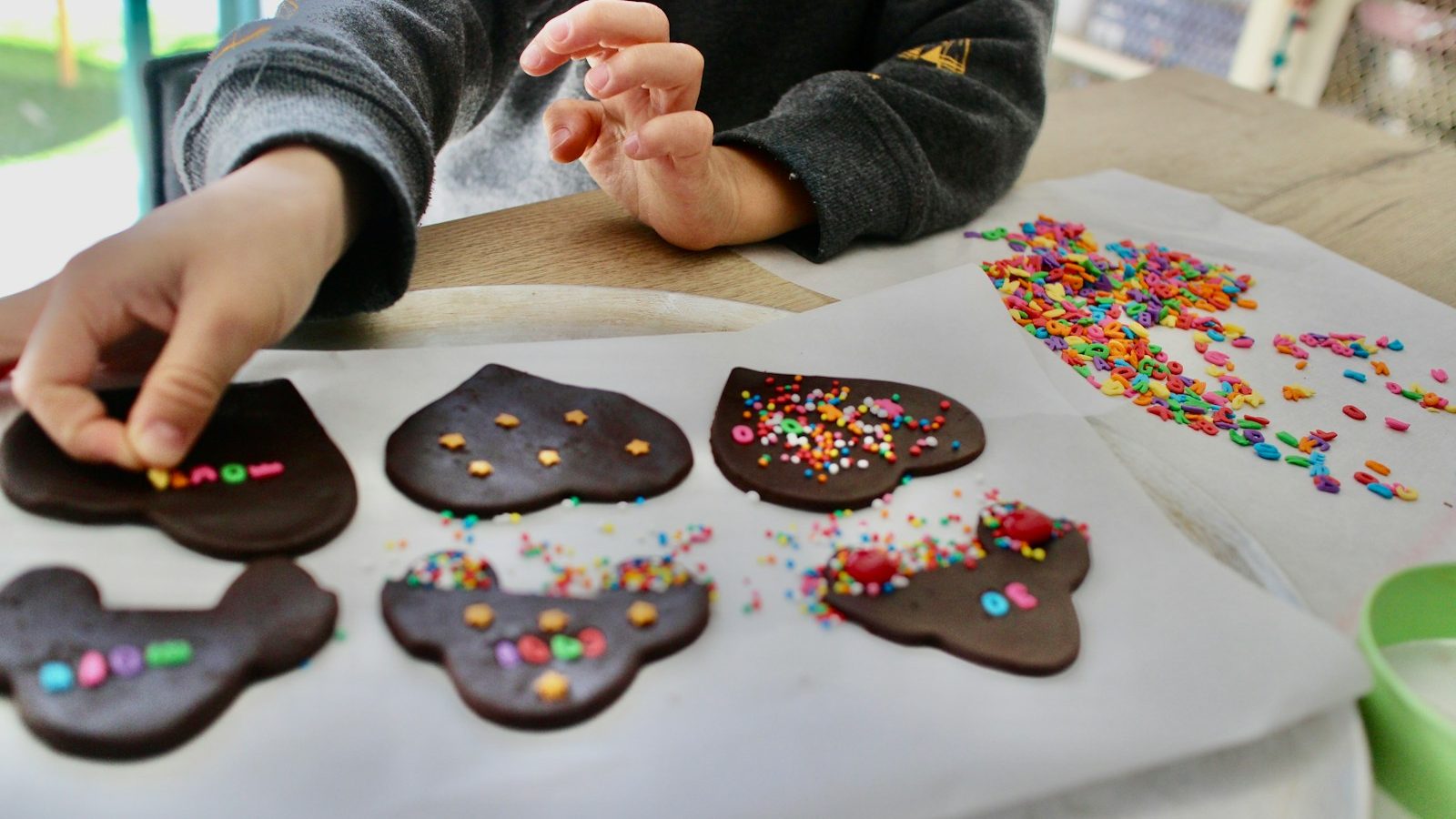 person holding brown and white heart shaped cookies