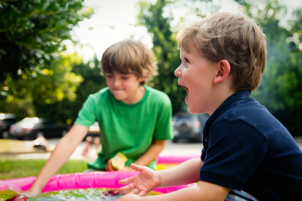 boy in blue shirt screaming near boy in green crew-neck shirt. 7 Best Educational Apps for Kids