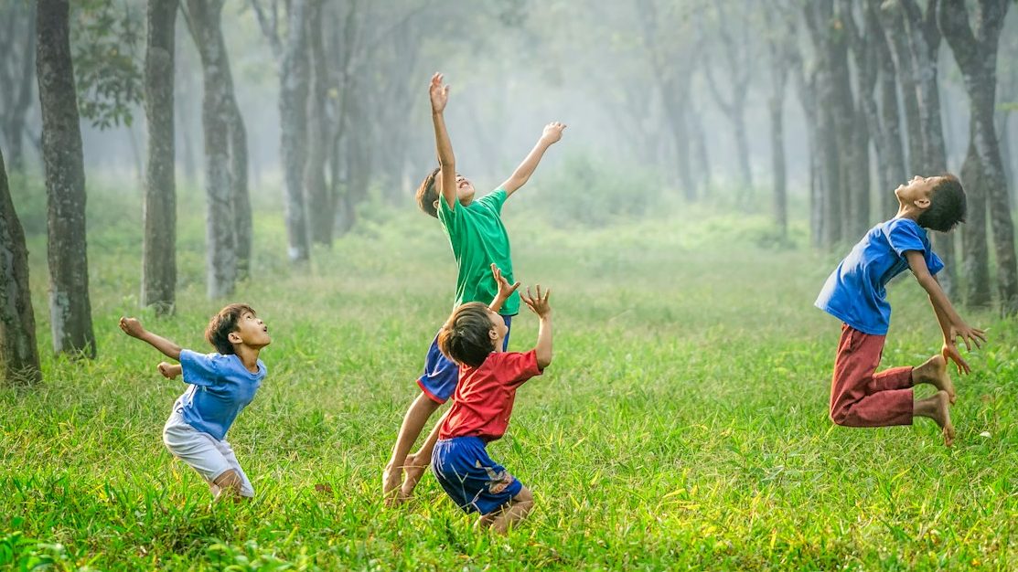 four boy playing ball on green grass, 10 Amazing Activities to Do with Your Kids This Weekend