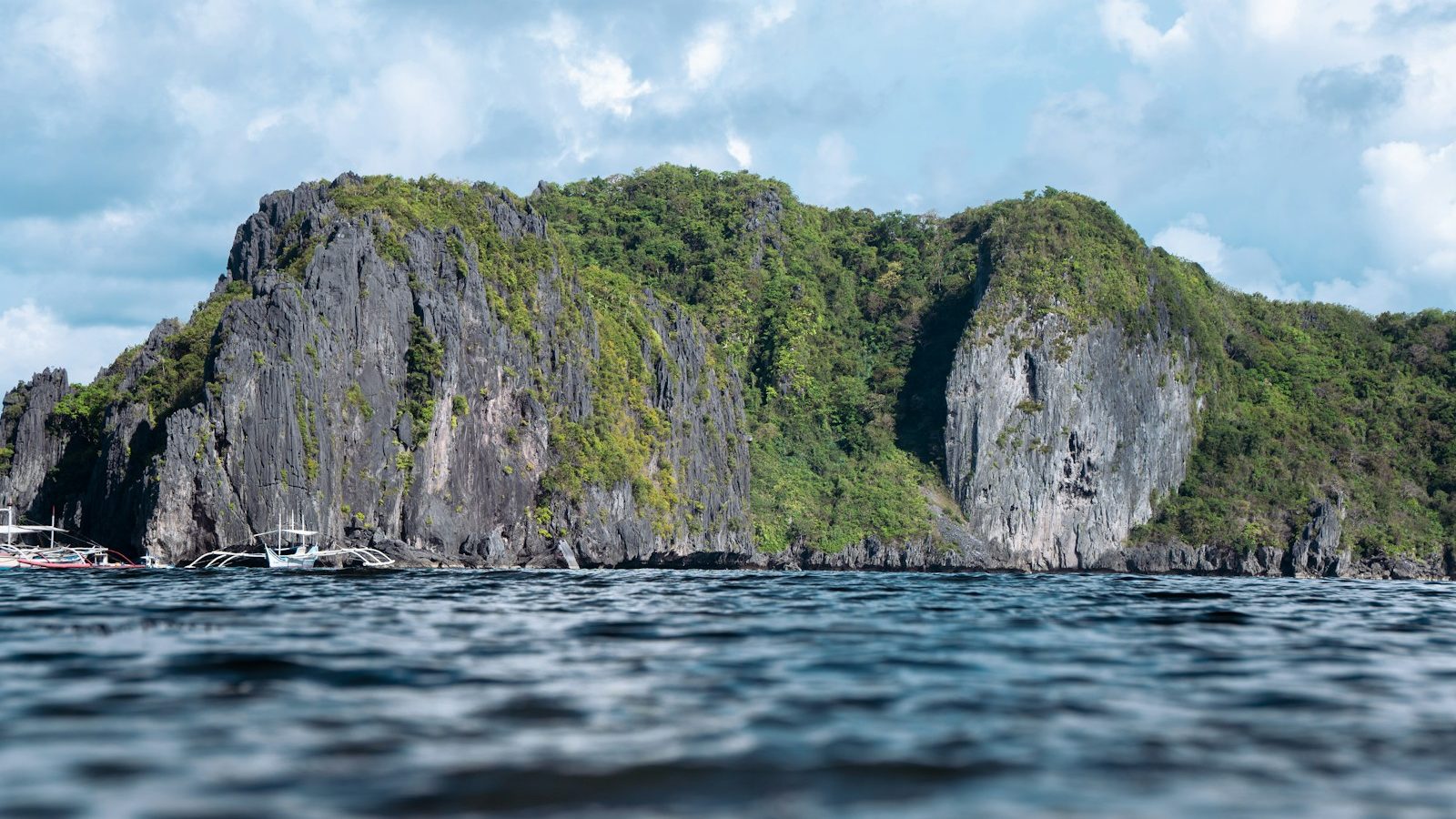 a group of boats floating on top of a large body of water