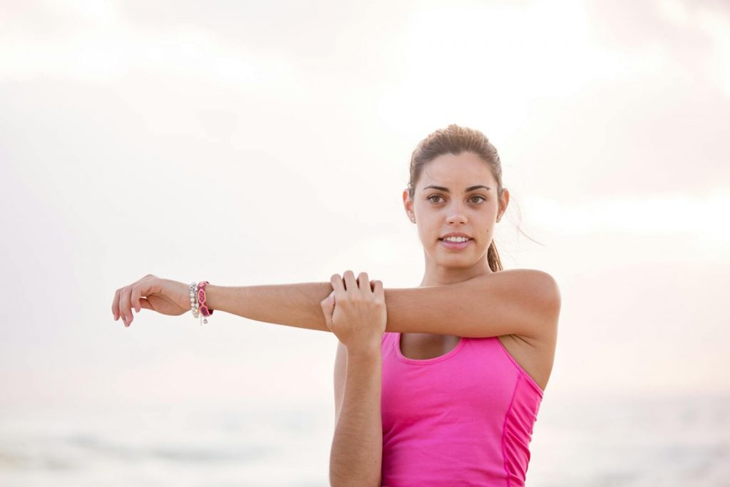 Photography of Woman in Pink Tank Top Stretching Arm, The Importance of Oral and Mental Health